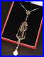 Superbe-pendentif-style-Art-Nouveau-en-argent-onyx-rubis-perle-et-marcassites-01-gwuu